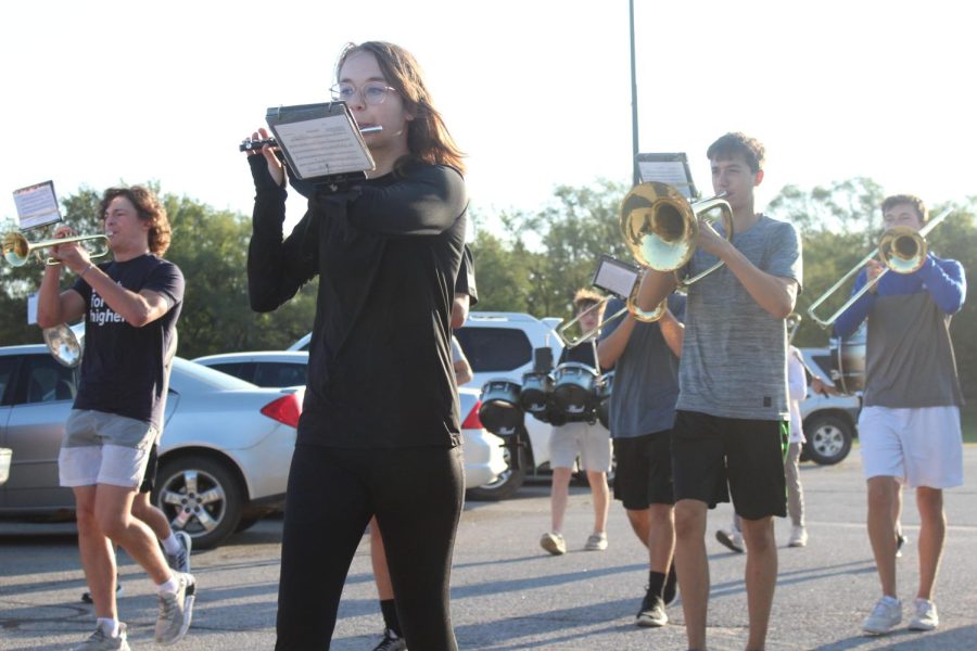 Band students Paul Kirchmann, Emma Cheshek, Carter Tichota  and Jackson Gayer march in the parking lot.  The band practiced marching in the parking lot leading up to the homecoming parade.