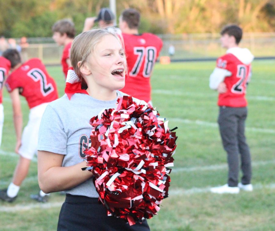 Sophmore Bella Tederman cheers at a home football game. This is Tedermans first year as part of the cheer team.