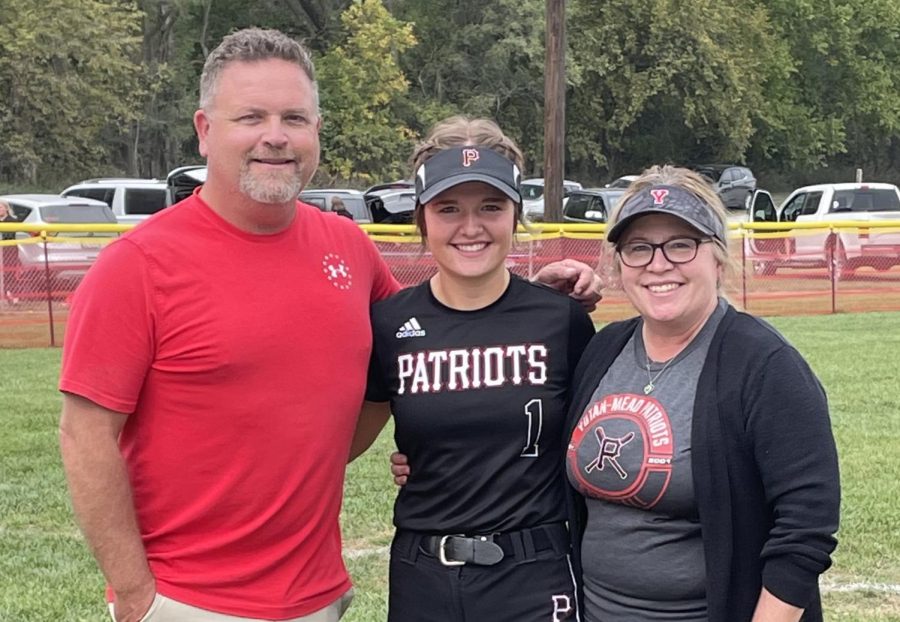 Sophomore Maycee Hays poses with her parents, Kelly and Jessica Hays, after the Yutan-Mead Patriots won the District Championship game. Maycee caught and hit for the team during the two games against the Aquinas Monarchs.