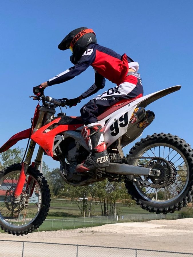 Kasen Scott flys through the air on his dirt bike. One of Scotts favorite parts of riding dirt bikes is the jumps. (Courtesy Photo)