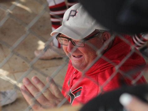 Assistant softball coach Mike Davis laughs with his fellow coaches at the state softball tournament. During his time at Yutan, Davis has coached softball, football, basketball, and track.