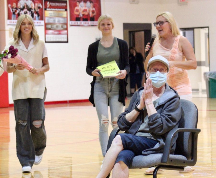 Christi Garbowski prepares to react to the encouraging messages that were put together in a video for the assembly. Seniors Brennan Jacobs and Haley Bedlan make their way to Grabowski to present her with gifts. Along with them, technology teacher, Amy Arensberg is MCd during the assembly.