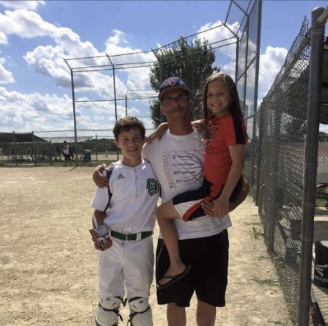 Paul and Allison Kirchmann pose with their dad, Scott Kirchmann, after a baseball game. As a strength coach, Scott was very supportive of his kids athletics.