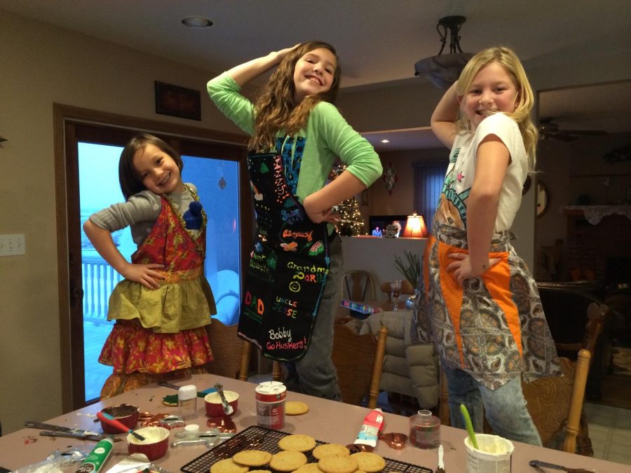 Junior Alexa Schneider (middle), spends time baking with her two cousins. Schneider will head to Benkelman, NE to carry on the Christmas tradition again this year.