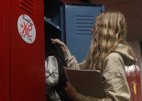 Freshman Riley Hannan puts her backpack in her locker after she gets to school. Students are only allowed to have their bags before school and during AP.