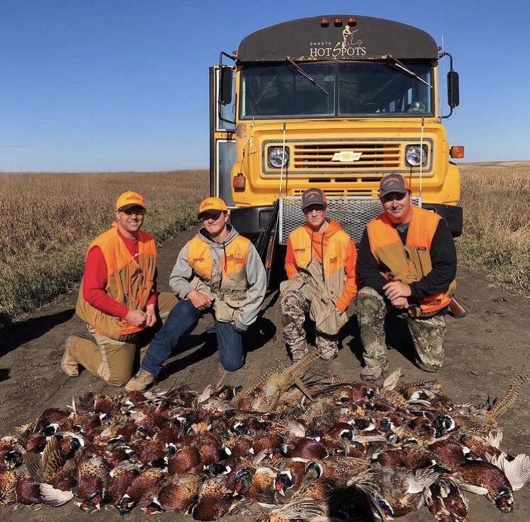 From left to right, Adam Wacker, Derek Wacker, Zach Kennedy and Scott Kennedy pose with the pheasants that they shot. The Wackers and Kennedys went on a trip to South Dakota to hunt with people from multiple states. 