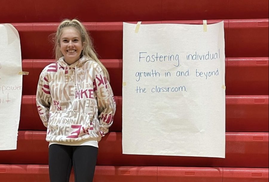 Freshman Jade Lewis stands next to her groups mission statement draft. In the large group session, this draft was modified to create the final mission statement.