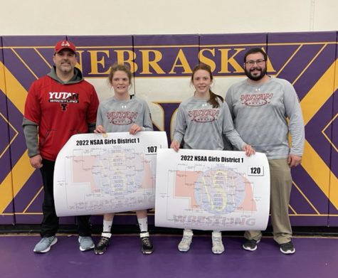 Freshmen Aubrie and Alexis Pehrson pose with their winning brackets at districts. Both Pehrsons are ranked number one in the state for their weight classes. 