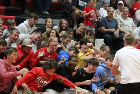 Senior Gavin Kube leads the student section in a roller coaster cheer. During the fall, the student section fueled the energy for the athletes who performed. Many students are hoping to get that energy back. 