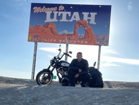 Math teacher Joel Carrillo poses in front of the Utah sign on the state border. On his journey, Carrillo stopped in four different states. 