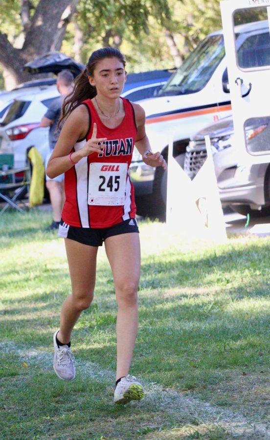 Mead junior Eva Georgoulopoulos strides to the finish at the Walnut Grove. Georgoulopoulos is involved in cross country, basketball, and track for highschool sports. 