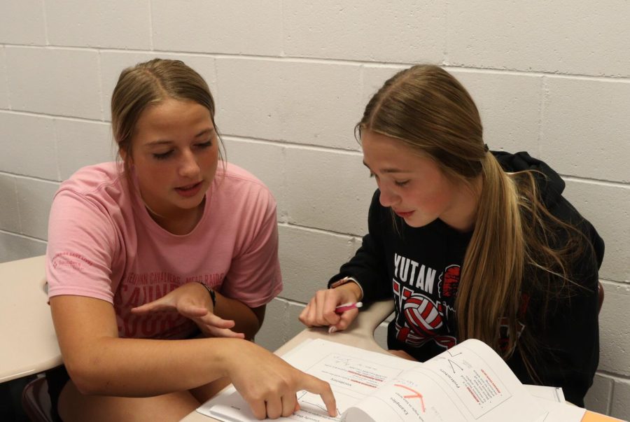 Sophomores Rylee Kirchmann and Britney Zeleny work together to finish up math homework during Access Period. This year, Access Periods are extended by 5 minutes but are only scheduled twice a week.