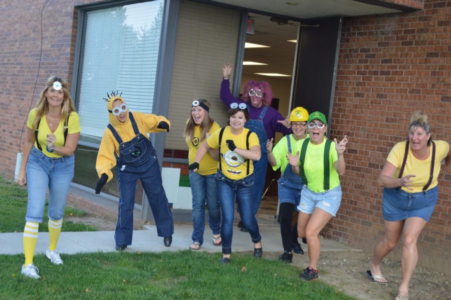 Yutan staff members (left to right) Michelle Dooley, Ginger Eikmeier, Sarah Portis, Natalie Zabrocki, Brian Sass, Kathy Lewis, Amy Arensberg and Chris Feller take a funny picture together during the 2014 homecoming week.  Zabrocki enjoyed getting creative with homecoming and Halloween dress-up days.