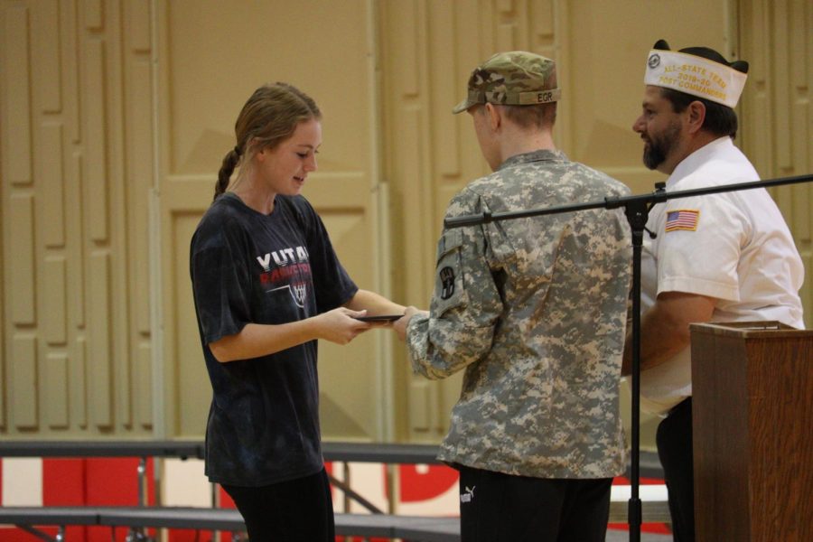 Senior Alyssa Hussing receives her third place award for her Voices of Democracy essay about why veterans are important. Awards were given out by Yutan VFW commander John Martin and Yutan junior Honorary Command Sergeant Major Ollie Egr.