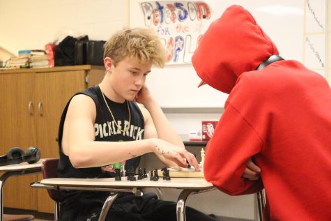 Junior Ethan Eggen plays a game of chess against eighth-grader Otto Henkel. Eggen is a relatively new player and is eager to learn more.