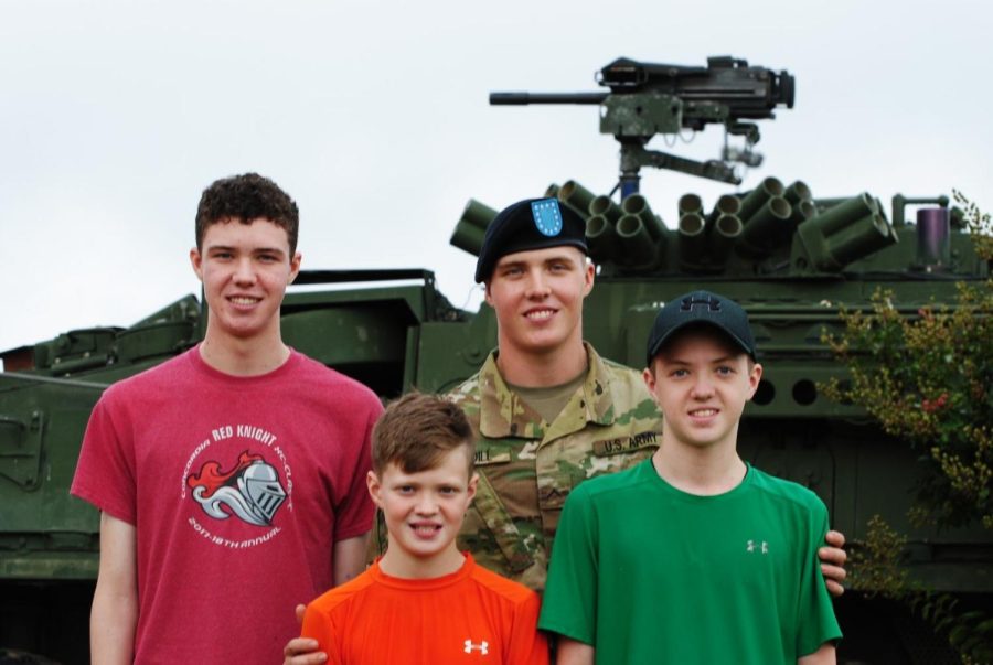 From left to right, brothers Garrison, Clark, Logan and Grayson Cogdill stand in front of a military vehicle. The oldest brother, Logan, has just finished basic training when the family came to visit in 2018.