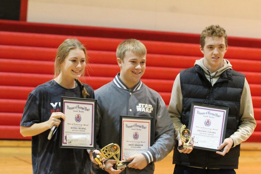 Seniors Alyssa Husing, Grayson Cogdill and Zach Krajicek pose for a picture with awards from their Voices of Democracy essay. Husing was awarded third place while Cogdill received second. Krajicek won first place with an essay about why a veteran is important and received a cash prize of $100.