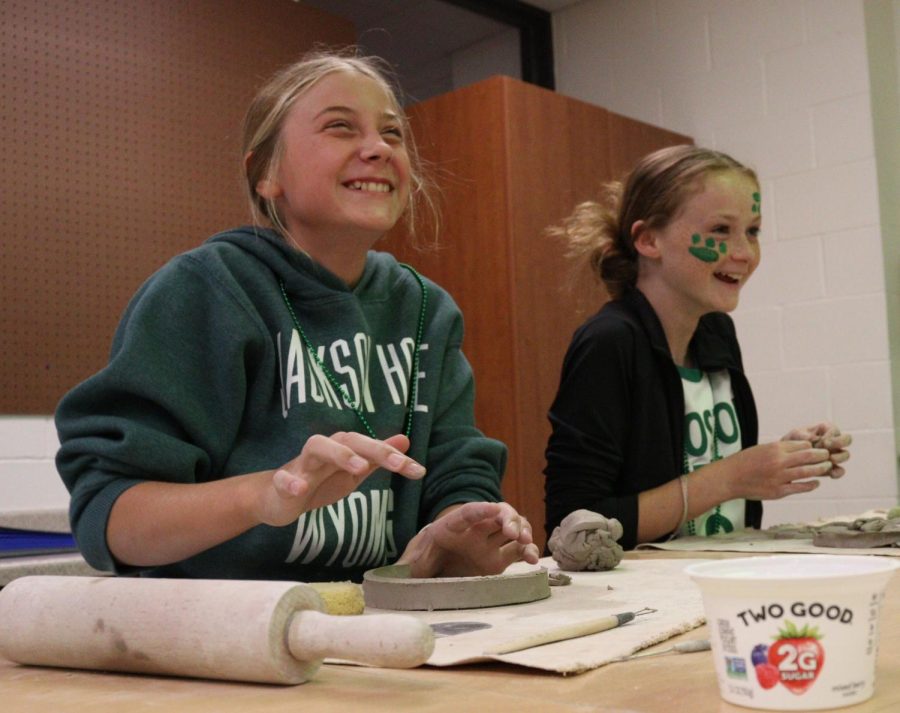 Eighth graders Emmy Tederman and Lexi Engel share a laugh while working on their art projects dressed in green. Each grade decorated a hallway in the same color they were wearing for Color Day. “I thought the hallways for Color Day were colorful and bright,” said Engel. 