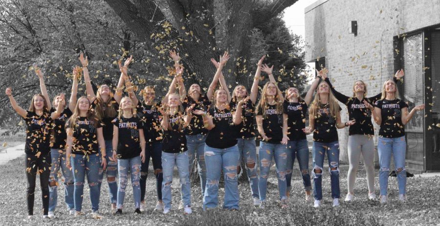 Members of the state championship softball team celebrate their win with some fun in the fall leaves. Pictured from left to right are Molly Besch, Kylie King, Addi Smith, Andi Nelson, Adie Gale, Rylee Kirchmann, Delaney Shield, Alexis Polak, Kaiti Hansen, Taylor Novak, Alyssa Husing, Maycee Hays, Shaylynn Campbell, Ella Watts and Laycee Josoff.
