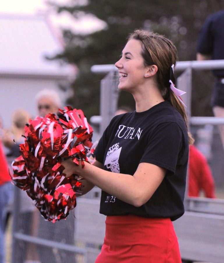 Junior Maura Tichota cheers at a home football game. Tichota has been cheering for 3 years and was elected captain this year.