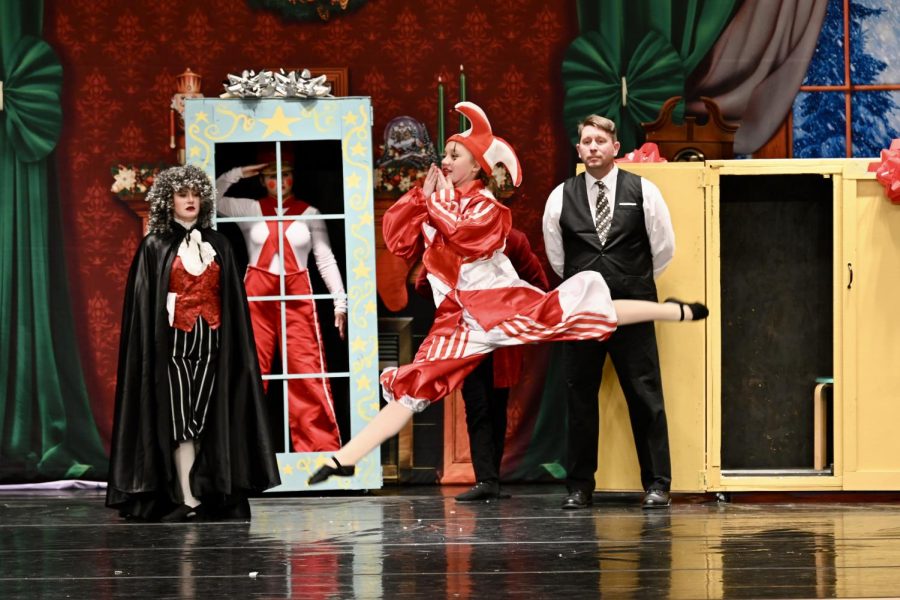 Freshman Kylie Krajicek leaps across the stage as the harlequin doll in the 2021 production of The Nutcracker. Krajicek has played over 20 roles in her time performing The Nutcracker at RSDA.