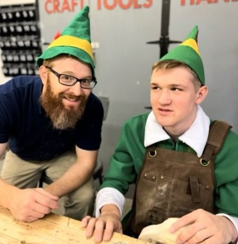Junior Ollie Egr and shop teacher Brandon Thoene pause their hard work to pose for a picture. Thoene has played a big role in helping Ollie create his wooden cars for the mission.