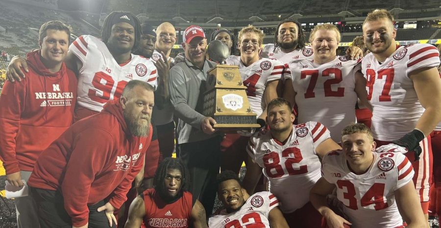 Colton+Feist+%2882%29+and+other+Husker+defensive+lineman+pose+with+the+Heroes+Game+trophy.+The+trophy+is+awarded+to+the+winner+of+the+annual+Black+Friday+game+between+Nebraska+and+Iowa.
