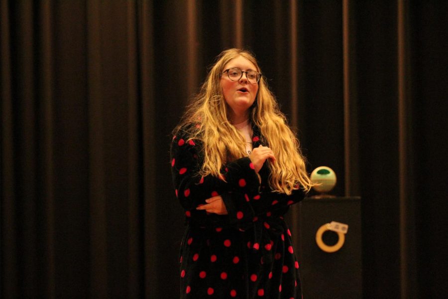 Junior Reagan Wilson acts in a play for one act as a crazy cat lady. Wilson plans on doing the all school play after one act.