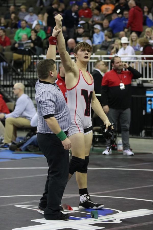 Junior Derek Wacker earns an arm raise after pinning his opponent in his first state match. Wacker ended his season with a record of 37-3.