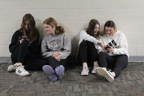 Sophomores Libby Winn and Aubrie Pehrson sit with Freshman Jenna Benjamin and Anna Rupp sit with each other and scroll through social media. We see this happen every day during lunch.