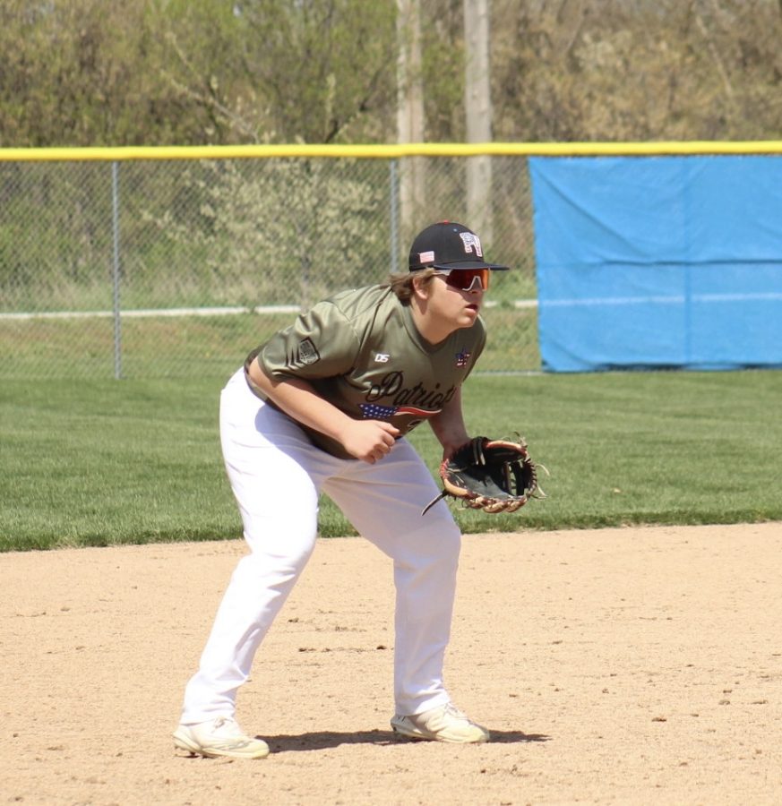 As the pitcher begins to throw the ball, junior Caleb Daniell gets in his stance to be ready to make a play. Daniell is the starting first basemen for the Patriots in the 2023 season.