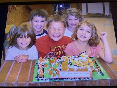 Brett Martain (back left), Emma Abraham (back right) and Zoie Nielsen (right front) smile with past classmates behind their Halloween project. Many Yutan seniors have been able to make memories with each other since kindergarten.