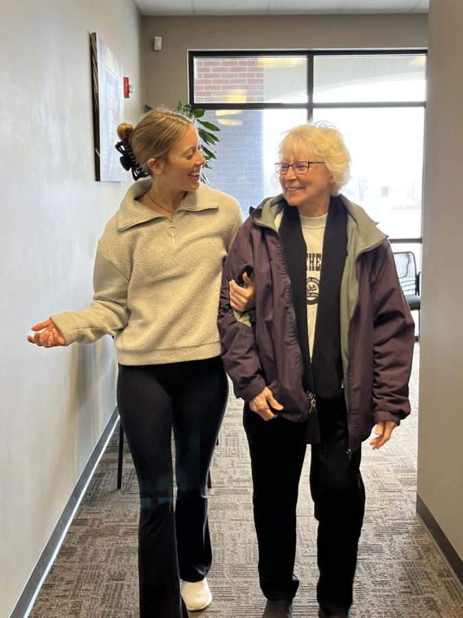Shaylynn Campbell walks down a hallway with a patient. Campbell spent her first internship at a hospital.