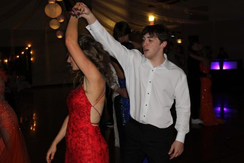 Senior Trevin Arlt spins senior Alyssa Husing at prom. This year many of the students did handshakes at the Grand March and swing danced throughout the night. 