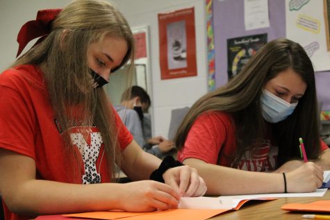 Seniors Abby Keiser and Zoie Nielson are placing recipes into their cookbooks. The girls took foods class as sophomores. 