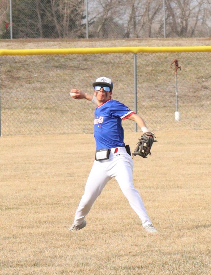 Senior Janson Pilkington throws the ball in during the game against DC West. Pilkington commonly played left field this year.