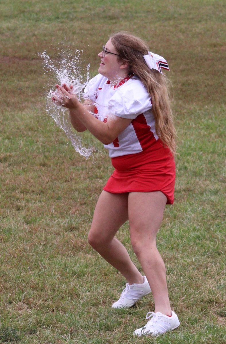 During the water balloon toss competition, senior Reagan Wilson braces herself as the balloon pops in her hands. This year, Wilson partnered up with fellow senior Haley Kube. “Even though I always manage to be the one that gets soaked, the water balloon toss is one of my favorite homecoming games,” Wilson said. 