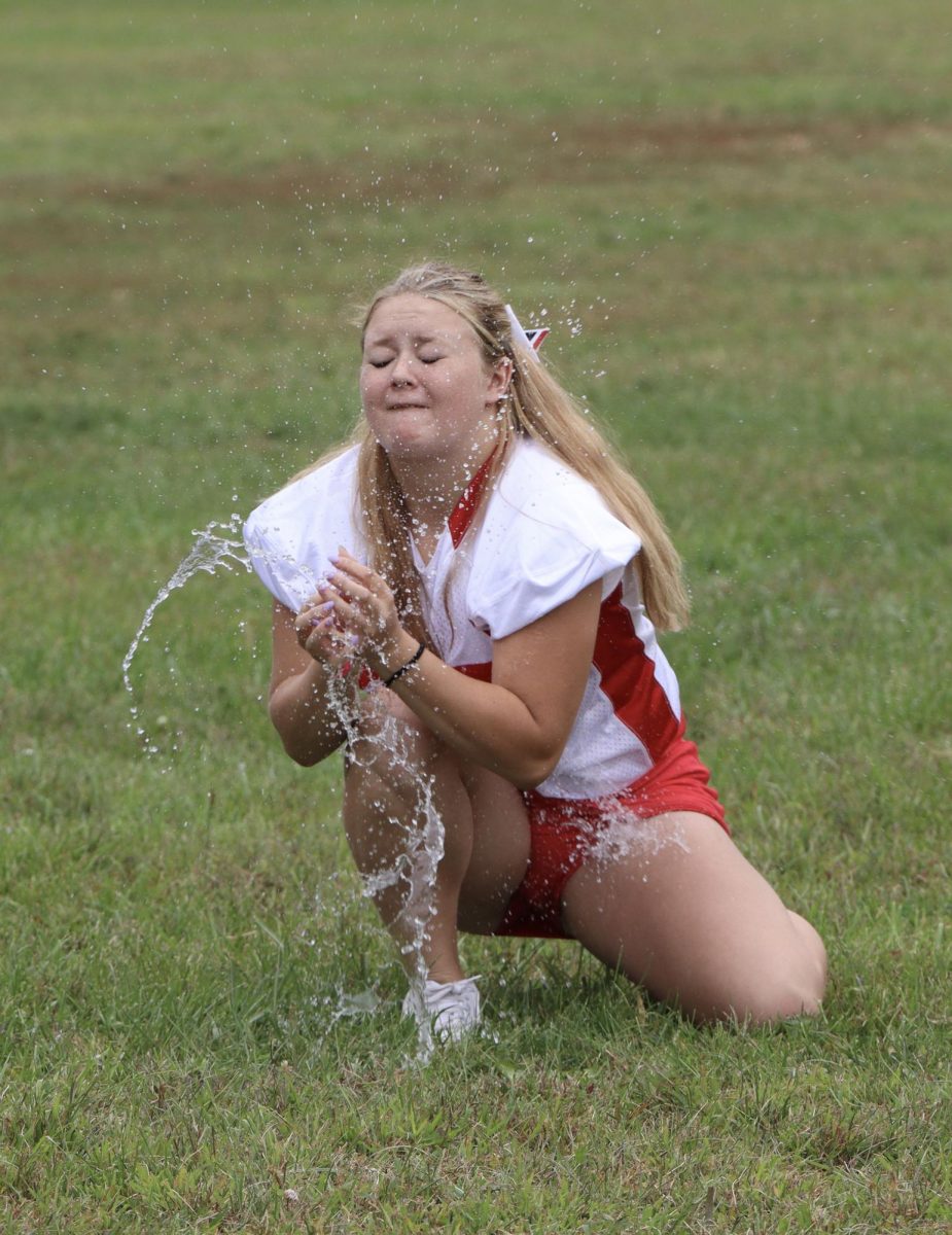Junior Saylor Eads kneels to catch a water balloon, which breaks after it lands in her hands. With everyone’s participation, the junior class ended up getting more combined points compared to the rest of the grades. “I am glad we beat the seniors in overall points since they always win,” said Eads.