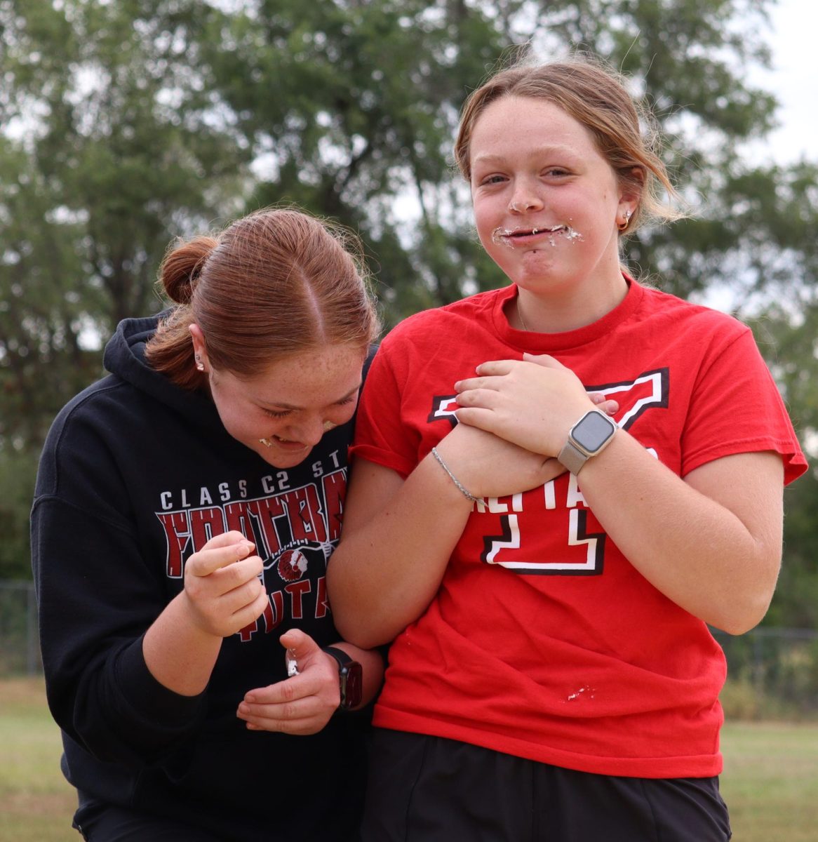 During the Chieftain Games, eighth-graders Ansley DeGroff and Kinsley Smith laugh while competing in the cupcake eating contest. Their team finished eight cupcakes. “It was fun,” said Smith. “You got to be competitive, plus I didn’t have my mom nagging at me to slow down in the competition.”