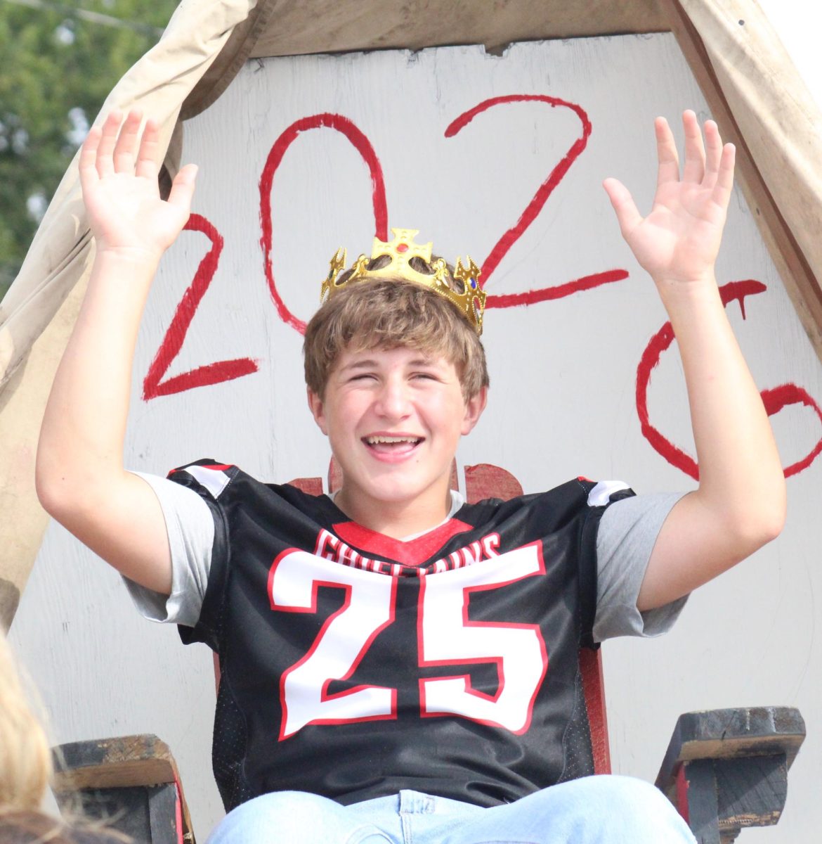 During the homecoming parade, sophomore Jaxon Wood imitates a king for his class’s float. Wood and his classmates decided to have the Tigers “bow down” to the Chieftains for their theme. “It was a lot of painting and setting up stuff, but it was really fun,” Wood said. 