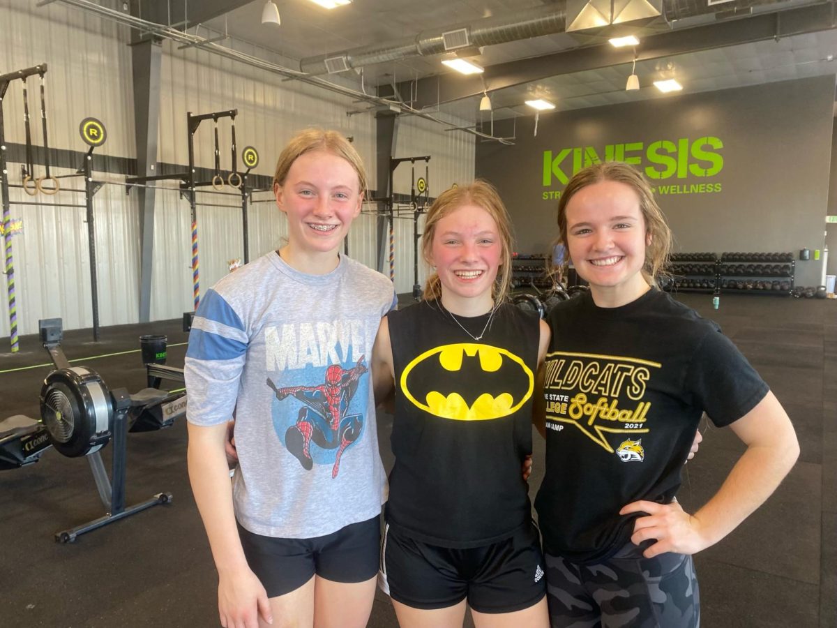 Right after they competed in their first Open workout Gabi, Bella and Maycee pose for a picture. Their gym had themes for each Open workout, this theme was super hero theme.