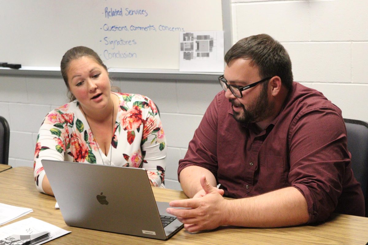 Student services director Tahler Novotny discusses the details of a student’s IEP with special education teacher Michael Swanson. Novotny was a special education teacher for eight years before moving into her new position.