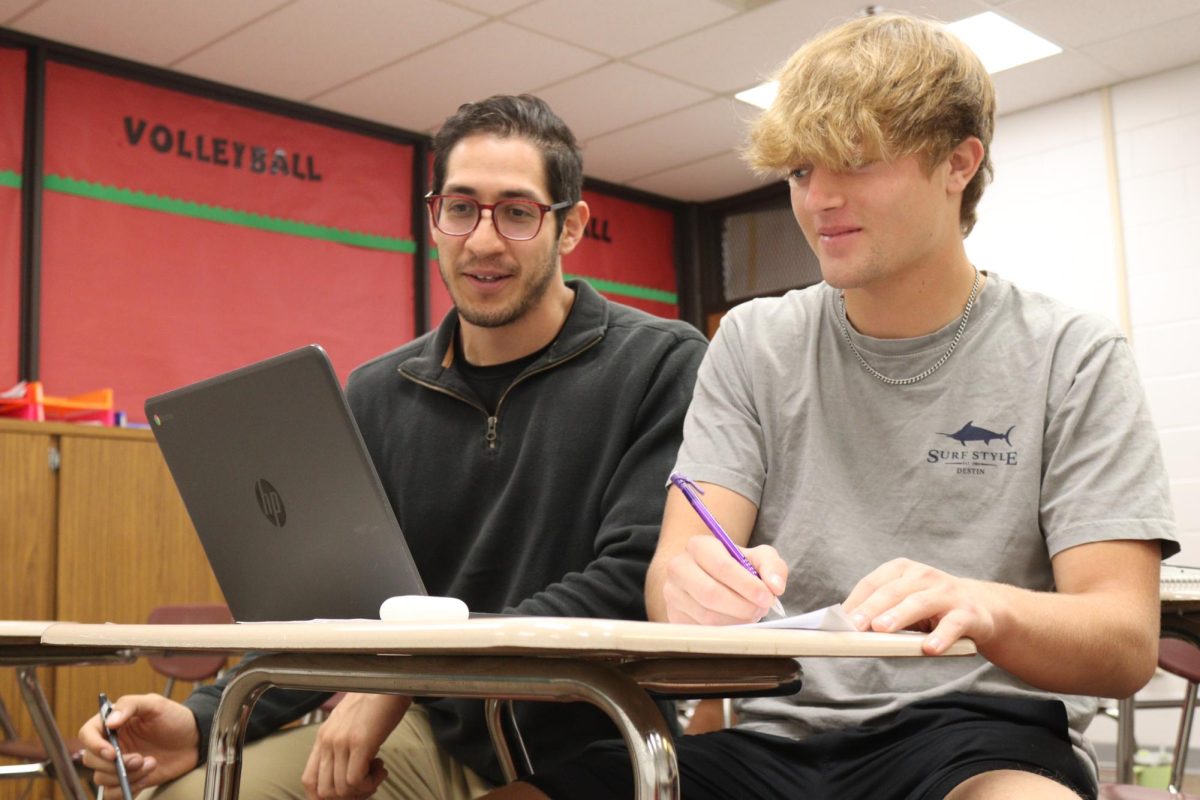Math teacher Joel Carrillo works with senior Cole Smith on his college algebra. Carrillo now walks without a boot or scooter. 