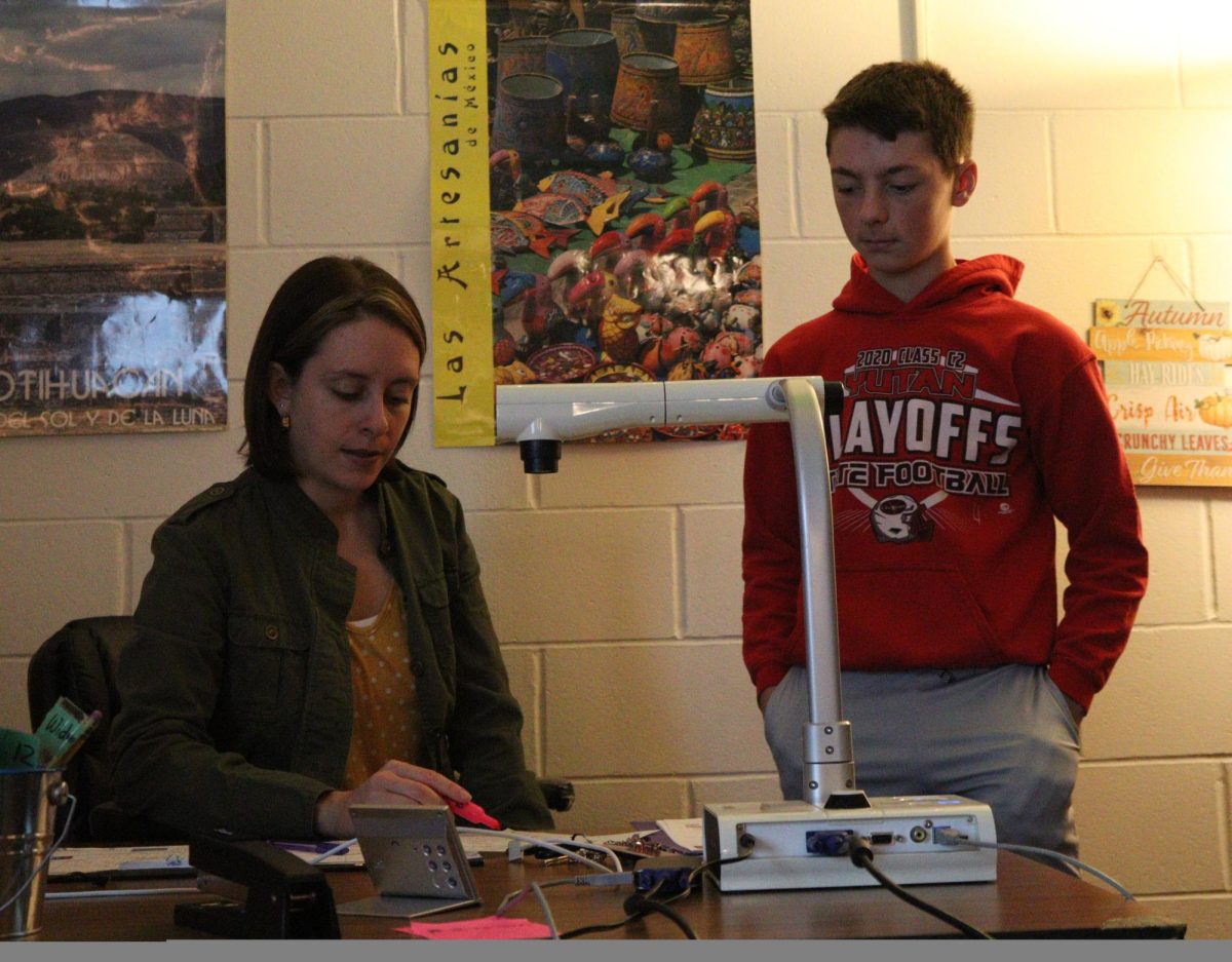 New Spanish proctor Megan Widmer helps freshman Carson Hollst with Spanish 1. Widmer proctors for 4 classes and spends the rest of her time supervising SENCAP.