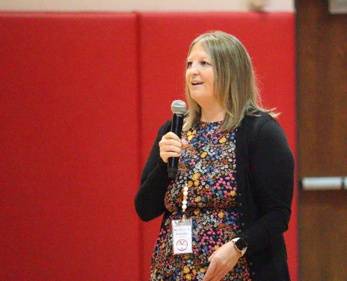 On the first day of school, Principal Stefanie Novotny speaks to the student body at an assembly. Novotny introduced herself and reviewed the student handbook.
