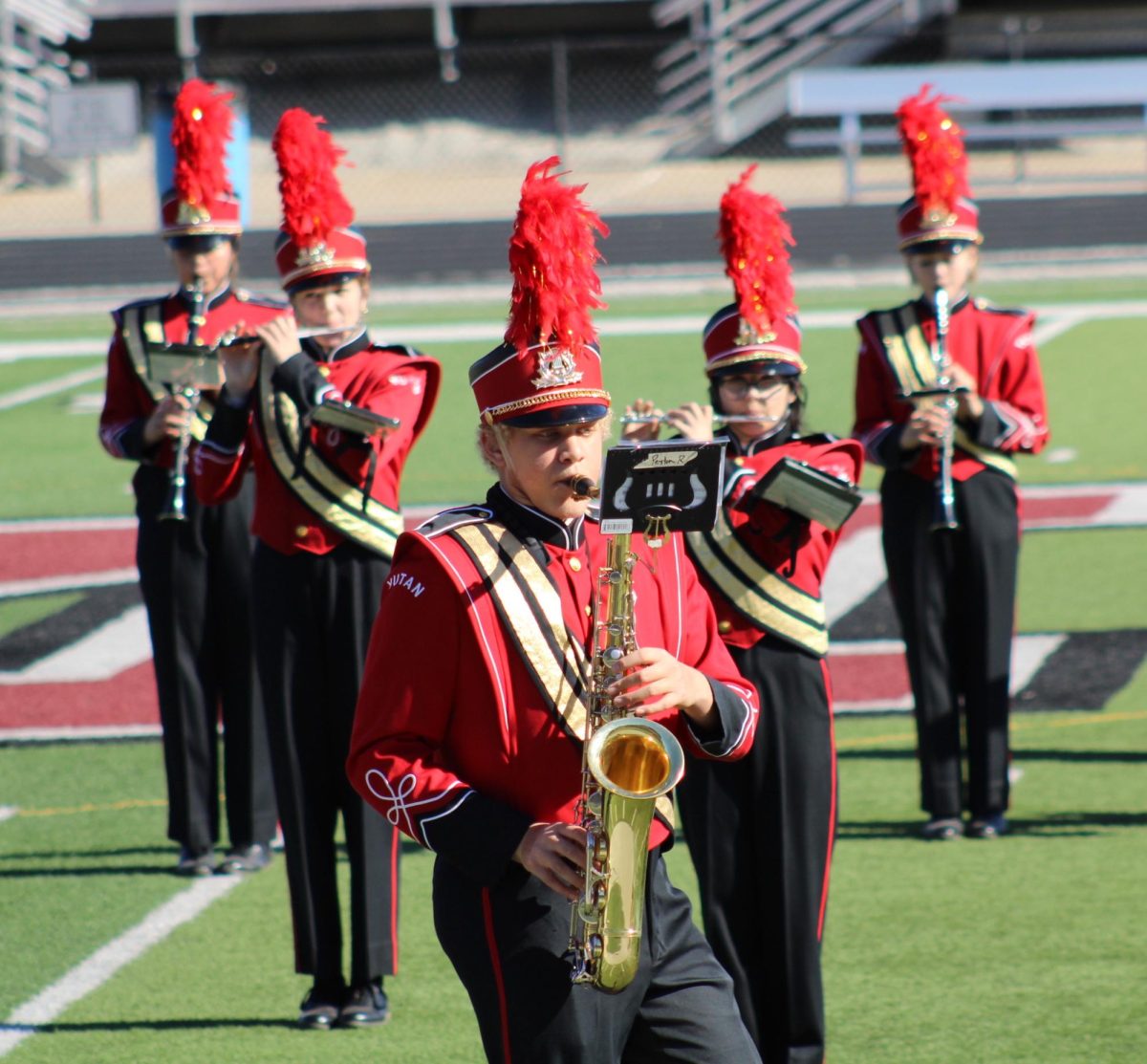 From left to right, Amalea Vaughn-Lantzer, Mylee Tichota, Peyton Reed, Brooklyn Bussing and Nicole Wacker march to a formation. Band director Hunter Holoubek hopes the band can memorize their field show music for competitions next year. 
