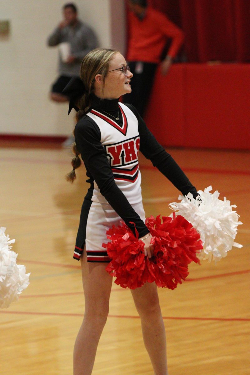 Freshman Lexi Engel cheers in her new uniform during a timeout. Much like the other cheerleaders, Engel enjoys the look of and style of these uniforms. 