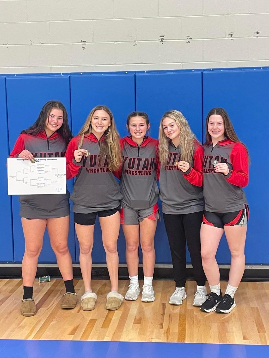 From left to right, freshman Amalea Vaughn-Lantzer, sophomore Jordyn Campbell, freshman Leah Thompson, sophomore Nicole Wacker, and freshman Ella Henkel pose for a picture after their wrestling meet at Bennington. Four of the five girls placed at the meet. 