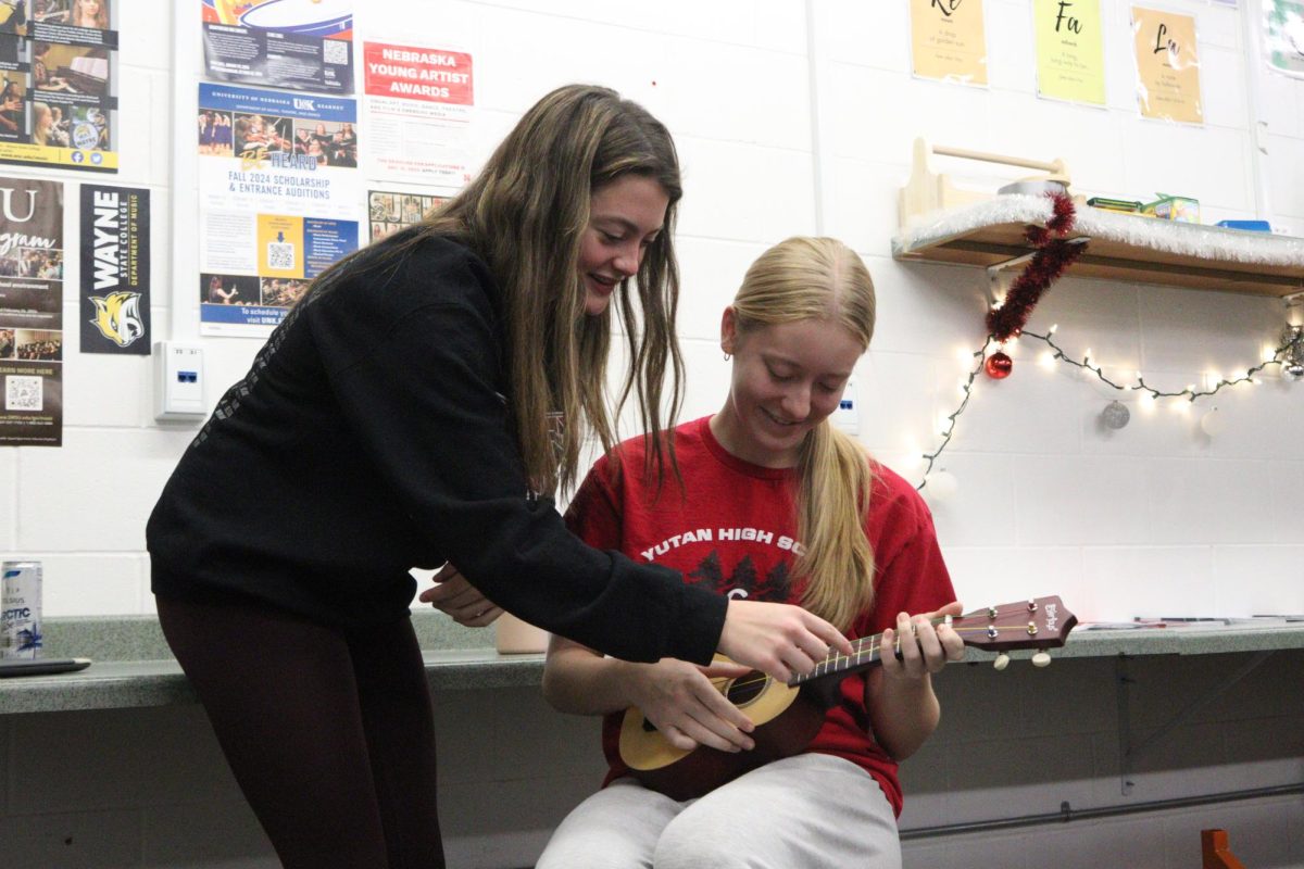 Sophomore Jenna Benjamin helps Sophomore Maddi Ledden with her Ukulele work. There are eight students in that class which is new this year.