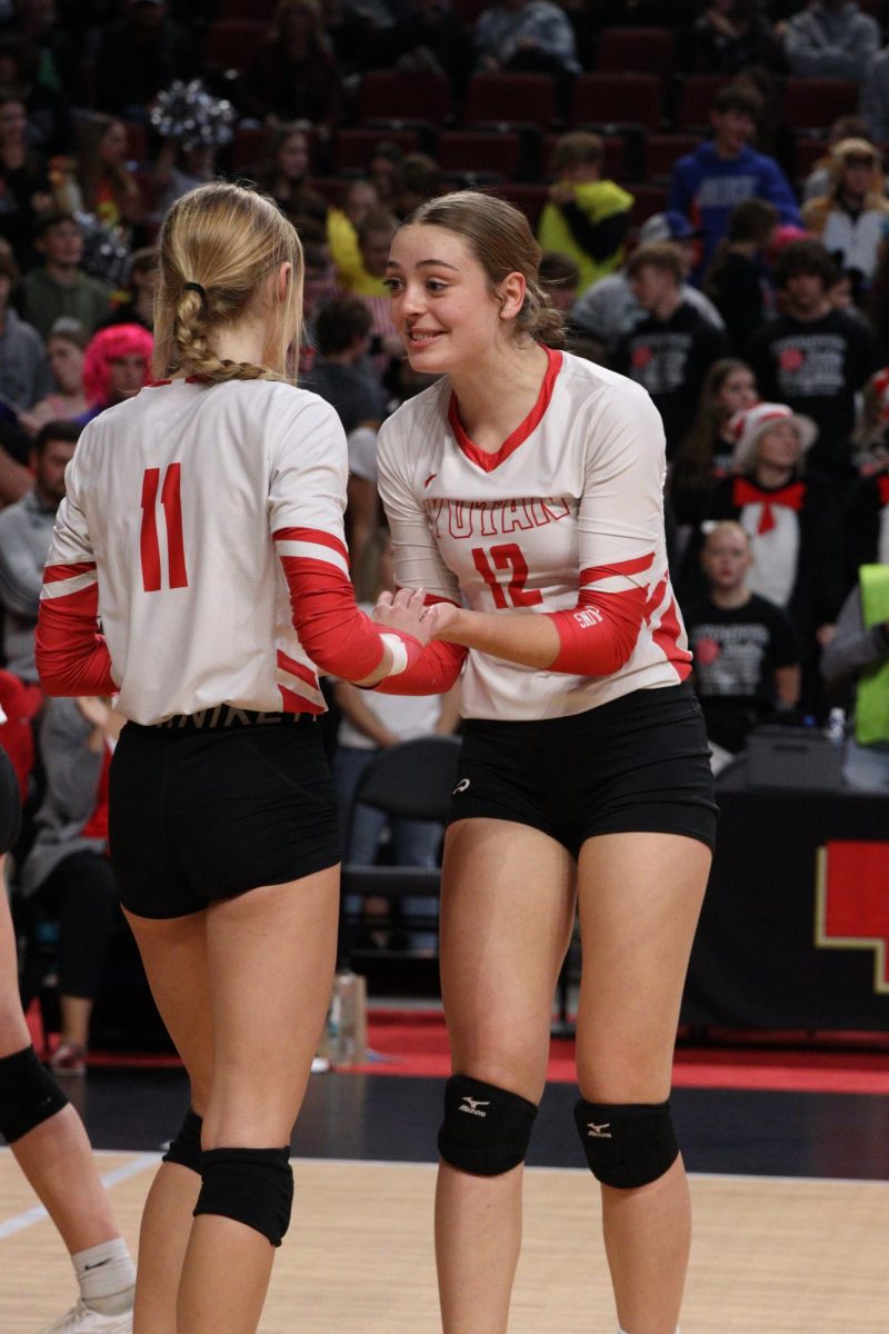 Junior Amelia (Millie) Dieckman high fives junior McKenna Jones at state volleyball. Dieckman played as a front row middle player who helped both defensively and offensively on the team.